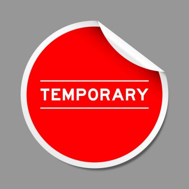 Red color peel sticker label with word temporary on gray background