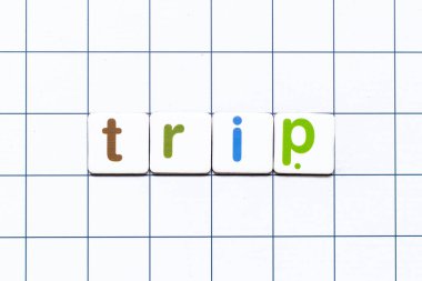 Colorful tile letter in word trip on white grid background