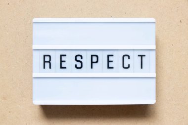Lightbox with word respect on wood background