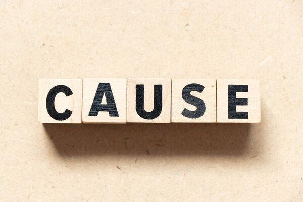 Alphabet letter block in word cause on wood background