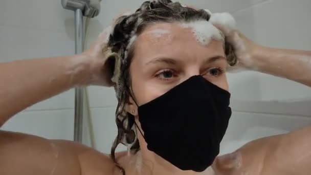 Jonge Charmante Vrouw Een Beschermende Zwarte Masker Wast Haar Haar — Stockvideo