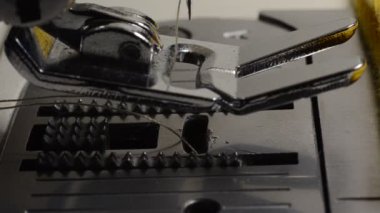 Tailor sews fabric for clothing on a sewing machine in a tailor shop