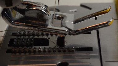 Tailor sews fabric for clothing on a sewing machine in a tailor shop