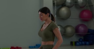 Athletic brunette girl performs a static plank exercise lying