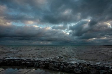 Dalgalar, bulutlar ve taşlarla Karadeniz üzerindeki dramatik gökyüzü