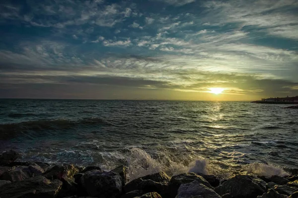 Dramatic sky over the black sea with waves, clouds and stones — Stock Photo, Image