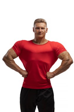 Portrait of an attractive athlete in a red t-shirt on a white cyclorama in the studio. Sports lifestyle.