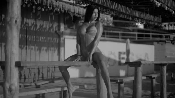 Beautiful Athletic Girl Swimsuit Sits Sexy Astride Beach Wooden Bench — Video Stock