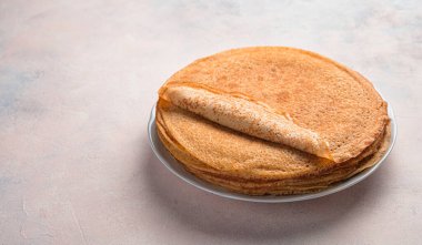 Pancakes for breakfast and carnival. A lot of pancakes are stacked. Thin, fried pancakes. Pancake day. Copy space