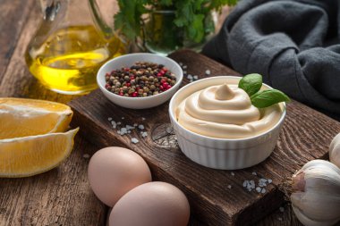 Natural mayonnaise and ingredients for its preparation. White sauce, homemade mayonnaise.