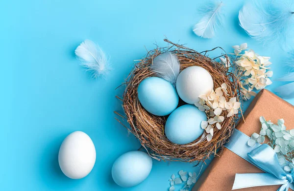 Blue White Eggs Nest Flowers Gift Feathers Blue Background Easter Stock Picture