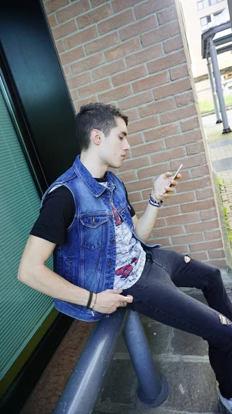 Handsome Boy Jeans Jacket Uses Smartphone High Quality Photo — 图库照片