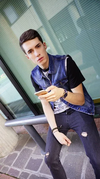 Handsome Boy Jeans Jacket Uses Smartphone High Quality Photo — Fotografia de Stock