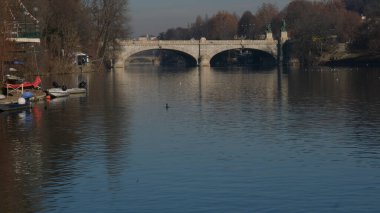 Torino 'daki Po nehri üzerindeki köprü Valentino parkından görülüyor. Yüksek kalite fotoğraf