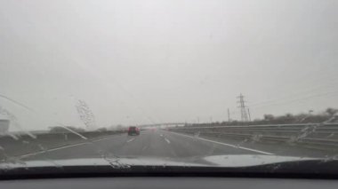 snowfall on the Italian highway from the passenger compartment