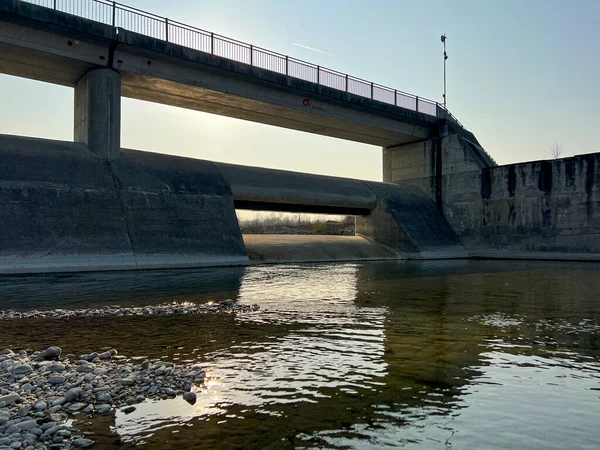 pedestrian bridge over the river Enza in Montecchio Emilia at sunset. High quality photo