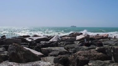 rocks and rough Ligurian sea in Italy Boccadasse. High quality 4k footage