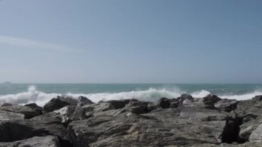 rocks and rough Ligurian sea in Italy Boccadasse. High quality 4k footage