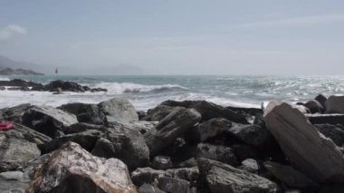 rocks and rough Ligurian sea in Italy Boccadasse. High quality 4k footage