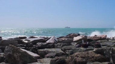 rocks and rough Ligurian sea in Italy Boccadasse. High quality 4k footage