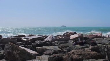 rocks and rough Ligurian sea in Italy Boccadasse. High quality 4k footage