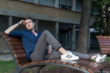 At kuyruklu güzel çocuk parkta bankta oturuyor. Yüksek kalite fotoğraf