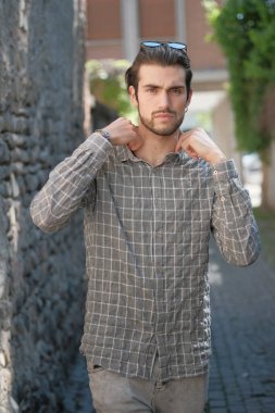 Yakışıklı, siyah saçlı İtalyan çocuk ortaçağ eski kasabasında geziniyor. Yüksek kalite fotoğraf