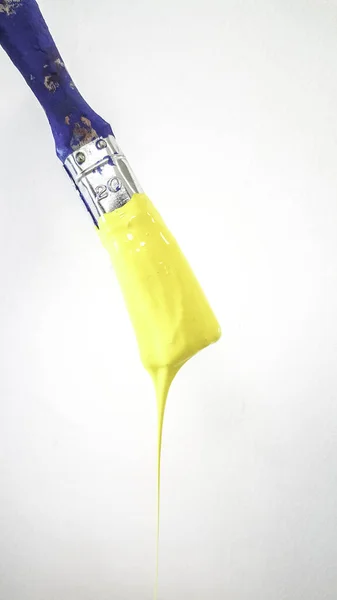 Paintbrush Dripping Yellow Paint White Background High Quality Photo — стоковое фото