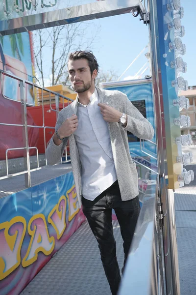 Güzel, siyah saçlı İtalyan çocuk terk edilmiş lunaparkta yürüyor. Yüksek kalite fotoğraf