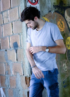 Güzel, siyah saçlı İtalyan çocuk inşaat halindeki fabrikada yürüyor. Yüksek kalite fotoğraf