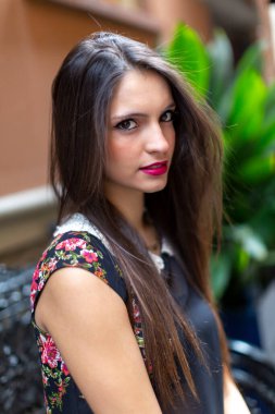 Güzel esmer, İtalyan bir kız bankta oturuyor. Yüksek kalite fotoğraf