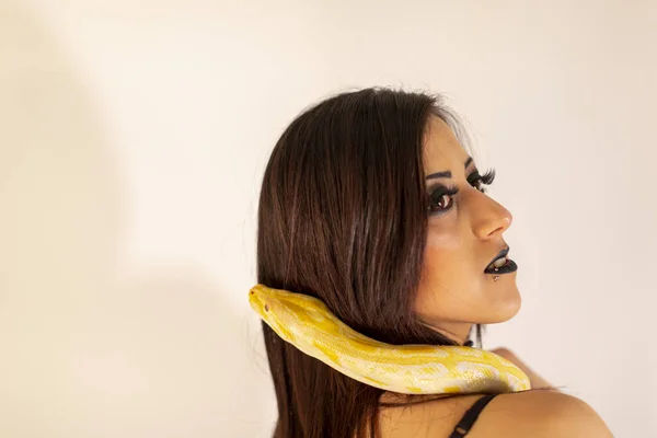 albino molur python with a dark goth brunette girl. High quality photo