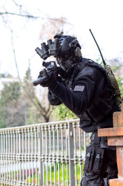 cosplayer military man armed with submachine gun with silencer and night vision. High quality photo