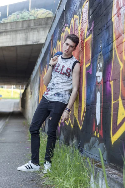 Şehir manzarasında koyu renk saçlı genç bir adam. Yüksek kalite fotoğraf