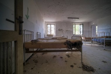bedroom with bed and wardrobe in old abandoned house. High quality photo