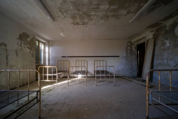 metal orphanage dormitory in old abandoned mansion. High quality photo