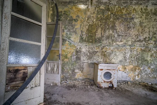 living room with old washing machine in old abandoned mansion. High quality photo