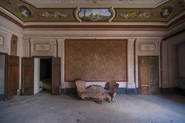 entrance with armchairs and sitting room in old abandoned mansion. High quality photo