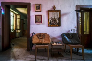 entrance with armchairs and sitting room in old abandoned mansion. High quality photo