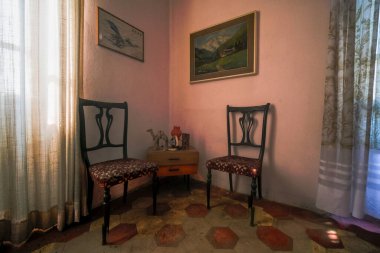 entrance with armchairs and sitting room in old abandoned mansion. High quality photo