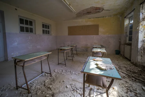 School desks for students in orphanage in old abandoned mansion. High quality photo