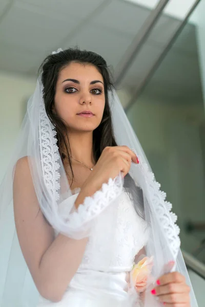 beautiful Italian brunette Mediterranean girl bridal in white wedding dress. High quality photo
