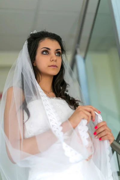 beautiful Italian brunette Mediterranean girl bridal in white wedding dress. High quality photo