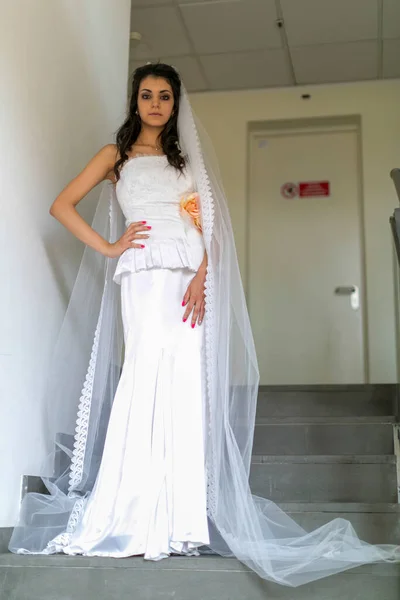 beautiful Italian brunette Mediterranean girl bridal in white wedding dress. High quality photo
