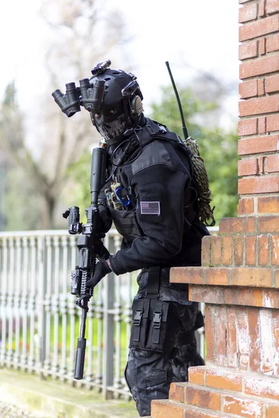 cosplayer military man armed with submachine gun with silencer and night vision. High quality photo