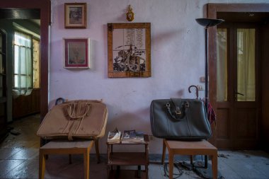 entrance with armchairs and sitting room in old abandoned mansion. High quality photo