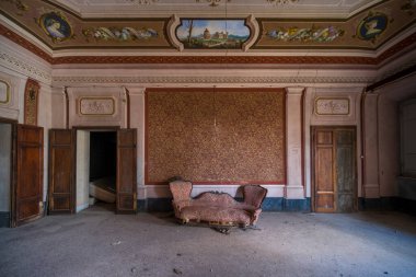 entrance with armchairs and sitting room in old abandoned mansion. High quality photo