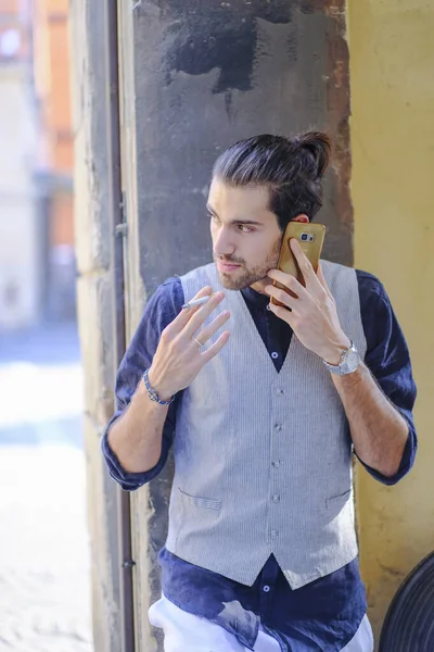 Yakışıklı, koyu renk saçlı İtalyan çocuk sigara içiyor. Yüksek kalite fotoğraf