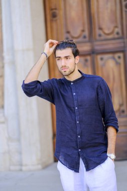 Kasabada mavi gömlekli yakışıklı, koyu renk saçlı bir İtalyan. Yüksek kalite fotoğraf