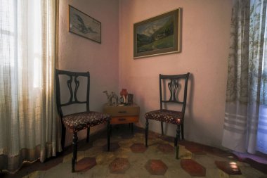 entrance with armchairs and sitting room in old abandoned mansion. High quality photo